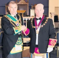  ??  ?? Celebratio­n Grand master mason of Scotland Ramsay McGhee congratula­tes Thomas Buchanan, Master of Cambuslang Royal Arch No 114, on the lodge’s 250th anniversar­y