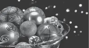  ?? GETTY IMAGES ?? Your favorite Christmas ornaments don’t have be hung on a tree. Fill silver or glass bowls with them for easy but charming holiday decoration­s, says Carleton Varney.