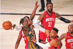  ?? MARK J. TERRILL/ASSOCIATED PRESS ?? The Thunder’s Dennis Schroder, left, is forced to pass the ball as the Rockets’ Russell Westbrook, bottom center, Jeff Green, above, and P.J. Tucker defend during Monday’s first-round playoff game in Lake Buena Vista, Fla.