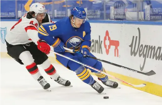  ?? JEFFREY T. BARNES/AP ?? Jake McCabe (right) signed a four-year deal with the Hawks as a free agent. The 27-year-old defenseman had played with the Sabres since the 2013-14 season.