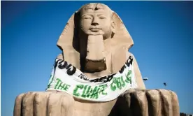  ?? Photograph: Stefano Guidi/Getty Images ?? A protest banner placed by climate activists on the sphinx outside the Egyptian Museum of Turin in Italy in July.