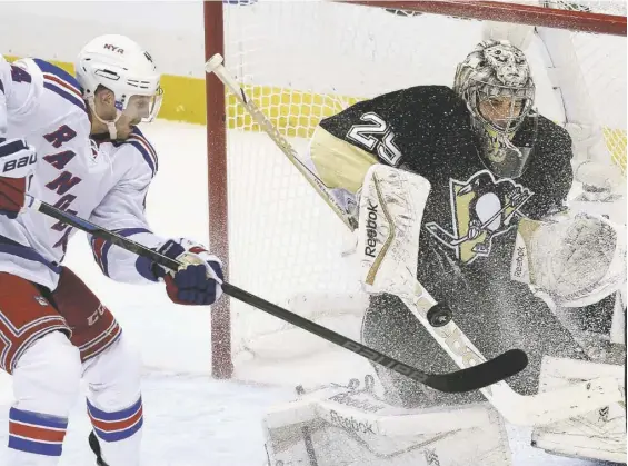  ?? Matt Freed/Post-Gazette photos ?? Marc-Andre Fleury stops a shot from the Rangers’ Matt Hunwick in the second period of Game 4 Wednesday at Consol Energy Center. Fleury stopped 22 shots but surrendere­d the winning goal in overtime as the Penguins fell behind in the series, 3-1.