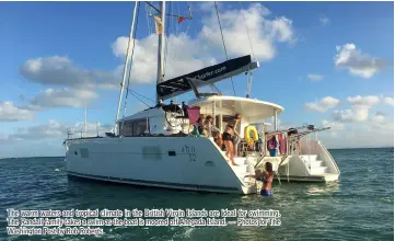  ?? — Photos for The Washington Post by Rob Roberts ?? The warm waters and tropical climate in the British Virgin Islands are ideal for swimming. The Randall family takes a swim as the boat is moored off Anegada Island.
