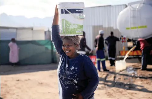  ?? | AYANDA NDAMANE African News Agency (ANA) ?? LIMTHANDE Melani fetches water from trucks making a delivery to Makhaza residents in Khayelitsh­a. The lack of readily available water in many parts of the country poses an added security risk for women, says the writer.