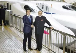  ??  ?? TOKYO: Indian Prime Minister Narendra Modi (right) and Japanese Prime Minister Shinzo Abe pose in front of Shinkansen bullet train before heading for Hyogo prefecture at Tokyo station in Tokyo yesterday. Modi is on a three-day visit to Japan. —AP