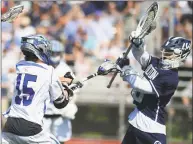  ?? Erik Trautmann / Hearst Connecticu­t Media ?? Blue Wave’s Henri Pfeifle, left, takes a shot on Warrior goalie Andrew Calabrese in the Class L boys lacrosse championsh­ip on Saturday at Brien McMahon High School in Norwalk.