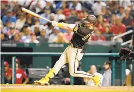  ?? MITCHELL LAYTON GETTY IMAGES ?? Padres infielder Jake Cronenwort­h hits a two-run home run in the seventh inning on Tuesday against the Nationals. It was one of four San Diego home runs.