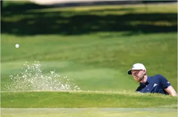  ?? David J. Phillip/Associated Press ?? ■ Daniel Berger hits out of a bunker on the first hole during the final round of the Charles Schwab Challenge golf tournament Sunday at the Colonial Country Club in Fort Worth, Texas. Berger won the tournament in a playoff round after Collin Morikawa missed a 3-foot par putt.