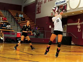  ?? Staff photo by Jerry Habraken ?? Pleasant Grove’s Blair Smith bumps the ball as Abbey Harjo watches on during the third set of their match against LibertyEyl­au on Tuesday night at the Rader Dome in Texarkana, Texas.