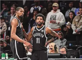  ?? Al Bello/TNS ?? The Brooklyn Nets’ Kevin Durant, left, and Kyrie Irving (11) look on in the final seconds of a 109-103 loss against the Boston Celtics during Game 3 of the Eastern Conference first-round playoff series on April 23 in New York.