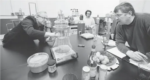  ?? PHOTOS: ELAINE THOMPSON/THE ASSOCIATED PRESS ?? Mike Steenhout, right, of Washington’s Liquor Control Board, watches as Eden Labs founder Fritz Chess talks about a closed extraction system at his lab in Seattle.