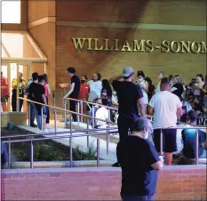 ?? Peter Yankowski / Hearst Connecticu­t Media ?? People wait outside the Danbury Fair mall on Aug. 11, after the non-fatal shooting of a teenage girl.