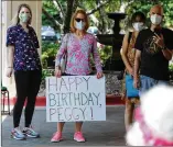  ??  ?? Friends and family members sing “Happy Birthday” to Peggy Cobb on her 105th birthday.