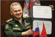  ?? (AP/Russian Defense Ministry Press Service/Vadim Savitskiy) ?? Russian Defense Minister Sergei Shoigu shows his signature on a roadmap for military cooperatio­n between Russia and China during a video call with Chinese Defense Minister Wei Fenghe in Moscow on Tuesday.