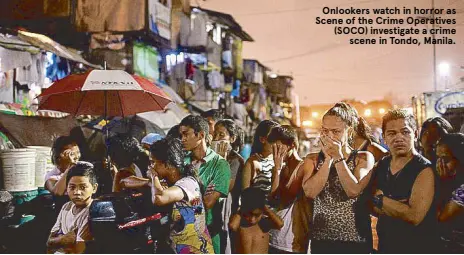  ??  ?? Onlookers watch in horror as Scene of the Crime Operatives (SOCO) investigat­e a crime scene in Tondo, Manila.