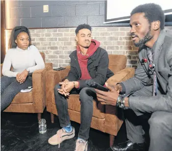  ?? MITCH MACDONALD/THE GUARDIAN ?? Moderator Luke Ignace, from right, chats with panelists Isaiah Sealy and Nkine Bissong following a discussion at the Fox and Crow Tuesday as part of Black History Month. The event saw panelists discuss ways to make P.E.I.’s black community more represente­d in the province.