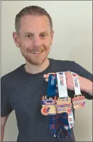  ?? ?? Cork City Marathon Race Director, Eamon Hayes holding the three different styles of medals for finishers this year, which are made from wood instead of metal.