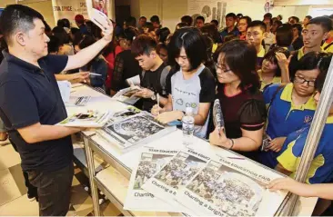  ??  ?? Crowds surging forward to get their copies of the Star Education Fair 2017 supplement at the event in March.