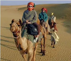  ??  ?? AN ELEPHANT SAFARI RETURNING TO CAMP AT DUSK ( LEFT); A CAMEL SAFARI EXPLORES THE BARREN BEAUTY OF THE THAR ( ABOVE)