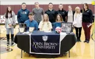  ?? Bud Sullins/Special to Siloam Sunday ?? Siloam Springs senior Ellie Lampton signed a letter of intent Wednesday to play volleyball at John Brown University. Pictured are: Front from left, father Carey Lampton, Ellie Lampton, mother Stacey Lampton; back, sister Lin Lampton, brothers Chris Lampton, Caleb Lampton and Luke Lampton; John Brown assistant volleyball coach Courtney Marshall, Siloam Springs assistant coach Kailey Greenleaf, former SSHS volleyball coach Rose Cheek-Willis, and current SSHS head coach Joellen Wright.