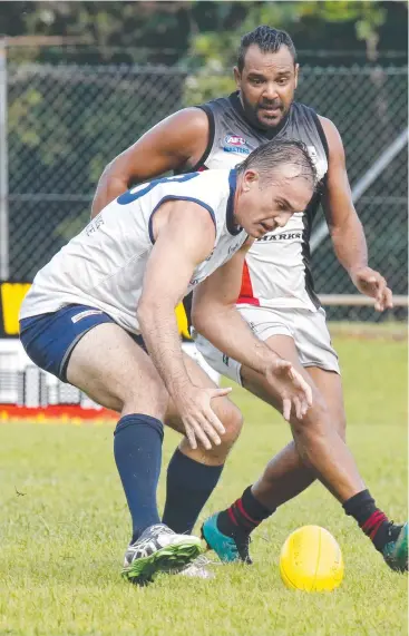  ?? Picture: ANNA ROGERS ?? TESTING CONDITIONS: Tommy Mooke and Rex Lehmann on the ball during the Masters Cairns Stingers v Townsville Sharks game.