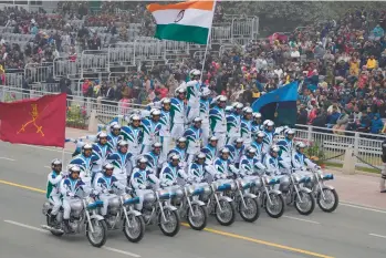  ?? MANISH SWARUP/AP ?? Balancing act: Indian army members display their skill on motorcycle­s during India’s Republic Day celebratio­ns Thursday in New Delhi. Tens of thousands, including Egyptian President Fattah El-sissi, braved chilly weather in the capital city to watch a parade that showcased India’s military might on the 73rd anniversar­y of the adoption of the country’s constituti­on.