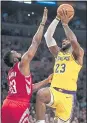  ?? KEVIN SULLIVAN — STAFF ?? LeBron James of the Lakers shoots over the Rockets’ James Harden on Saturday.