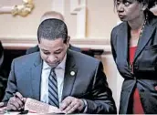  ?? DREW ANGERER/GETTY ?? Lt. Gov. Justin Fairfax, who has denied both accusation­s against him, reads a document on the Senate floor Friday.