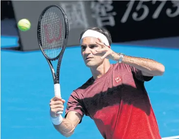  ?? REUTERS ?? Defending champion Roger Federer practises his shots.