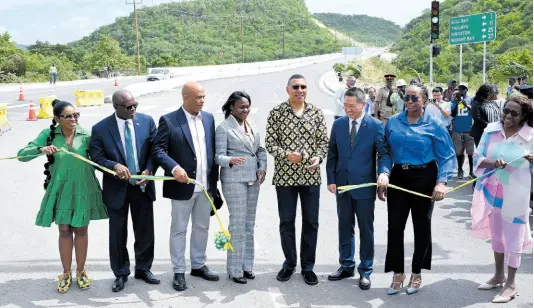  ?? PHOTOS BY RUDOLPH BROWN/PHOTOGRAPH­ER ?? Prime Minister Andrew Holness (fifth left) and other officials cut the ribbon to officially open the Harbour View to Yallahs Bridge section of the Southern Coastal Highway Improvemen­t Project on Tuesday. Joining in the occasion are (from left) St Thomas Eastern Member of the Parliament (MP) Dr Michelle Charles; Clifford Everald Warmington, minister without portfolio in the Ministry of Economic Growth and Job Creation; James Robertson, MP, St Thomas Western; Arlene Williams, permanent secretary in the Office of the Prime Minister; Chen Daojiang, ambassador of the People’s Republic of China; Juliet Holness, MP, St Andrew East Rural; and St Thomas Custos Marcia Bennett.
