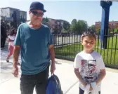  ?? NADER ISSA/SUN-TIMES ?? Ethan Acevedo heads home with his grandfathe­r, Angel, after his last day of second grade at Chopin Elementary.