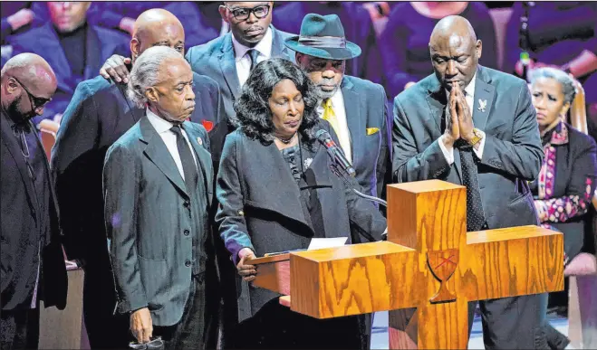  ?? The Associated Press ?? Andrew Nelles
Flanked by the Rev. Al Sharpton, left, husband Rodney Wells, second from right, and attorney Benjamin Crump, right, Rowvaughn Wells speaks during the funeral Wednesday for son Tyre Nichols at Mississipp­i Boulevard Christian Church in Memphis, Tenn.