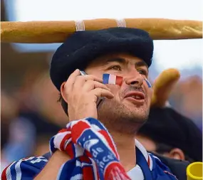  ?? — AFP ?? Filepic of a French supporter with a baguette on his head at a World Cup 2006 football match in Germany.