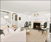  ?? Contribute­d by Houlihan Lawrence ?? A wood-burning fireplace in the living room makes the space especially cozy.