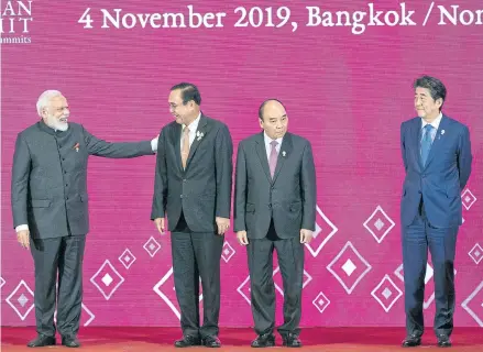  ?? AP ?? FROM LEFT Indian Prime Minister Narendra Modi, Thailand’s Prime Minister Prayut Chan-o-cha, Vietnam’s Prime Minister Nguyen Xuan Phuc and Japan’s Prime Minister Shinzo Abe stand on the stage before a group photo at the Asean Summit on Monday.