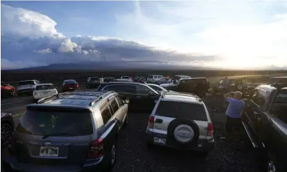  ?? ?? An overflow of cars sit in a parking lot near the Mauna Loa volcano as it erupts on Wednesday. Photograph: Gregory Bull/AP