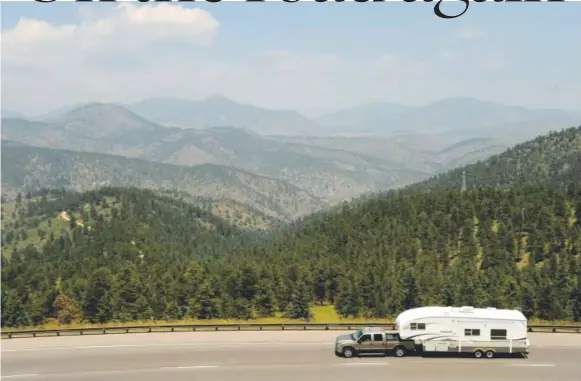  ?? Hyoung Chang, The Denver Post ?? A truck with a camper heads west on I-70.