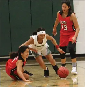  ?? MIKE BUSH/NEWS-SENTINEL ?? Lodi guard Calista Morita (left) and Liberty Ranch guard Jada Hightower battle for the loose basketball while Lodi center Veronica Alejandrez (23) watches during an area nonleague high school girls game at The Hawks Nest on Nov. 26.