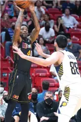  ?? AP Photo/Wilfredo Lee ?? ■ Miami Heat forward Udonis Haslem (40) makes a three-point shot against Indiana Pacers center Goga Bitadze (88) Tuesday during the second half of an NBA basketball game in Miami.