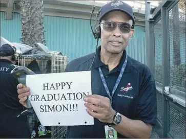  ?? Photograph­s courtesy of Brooks family ?? DODGER STADIUM ticket taker Errol Coffey sent his congratula­tions to Stan Brooks’ son, Simon, who graduated from high school in 2010. “It was like we got a picture with Kobe,” says Simon, who is 28 now.