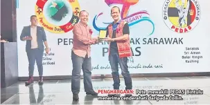  ??  ?? PENGHARGAA­N: Pete mewakili PEDAS Bintulu menerima cenderahat­i daripada Collin.