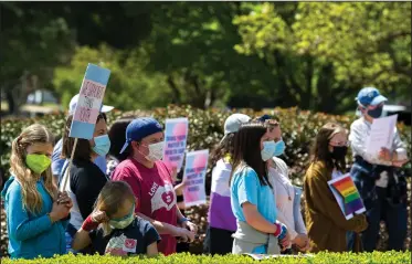  ?? (Arkansas Democrat-Gazette/Stephen Swofford) ?? Protesters gather Saturday at the steps of the state Capitol to call for Gov. Asa Hutchinson to veto House Bill 1570, which they say would prevent health care providers from treating or referring youths to evidence-based, gender-affirming health care services. More photos at arkansason­line.com/44protest/.