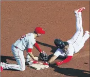  ?? WINSLOW TOWNSON — THE ASSOCIATED PRESS ?? Boston Red Sox’s Rafael Devers slides safely into second base with an RBI double as the throw gets away from Philadelph­ia Phillies’ Neil Walker during the seventh inning of a baseball game Wednesday at Fenway Park in Boston.