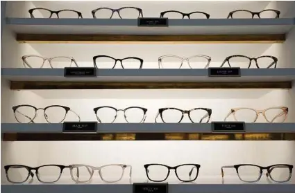  ?? Associated Press ?? Warby Parker lets you pick out five frames to try for free before committing to a pair.