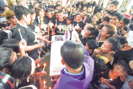  ??  ?? Relatives and friends gather around the coffin to bid farewell to Bladen Skyler Abatayo after the requiem Mass at the Mt. Carmel Church. The boy was laid to rest yesterday.