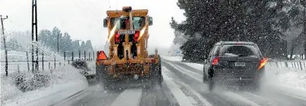  ?? PHOTO: BARRY HARCOURT ?? A grader clears snow on State Highway 94 between Te Anau and Mossburn yesterday morning.