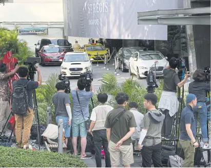  ?? PHOTOS BY AP ?? Members of the media wait outside the St Regis Hotel in Singapore ahead of the summit between US President Donald Trump and North Korean leader Kim Jong-un.