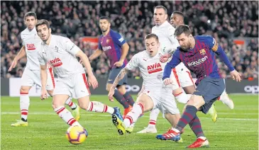  ?? REUTERS ?? Barcelona’s Lionel Messi, right, scores against Eibar for his 400th La Liga goal.