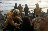  ?? AP PHOTO BY MONTEREY COUNTY SHERIFF’S OFFICE ?? In this Friday, July 13, photo, authoritie­s tend to Angela Hernandez, foreground center, after she was rescued in Morro Bay.