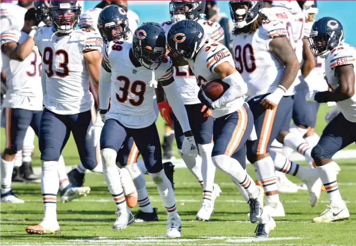  ?? GETTY IMAGES ?? Eddie Jackson ( 39) and DeAndre Houston- Carson celebrate after Houston- Carson’s pick in the Bears’ ugly win against the Panthers. The team was 5- 1, and it was all fun and games, but then the Bears lost to the Rams and Saints.